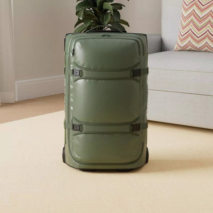 Green 25 inch gonex rolling duffle bag on a beige carpet